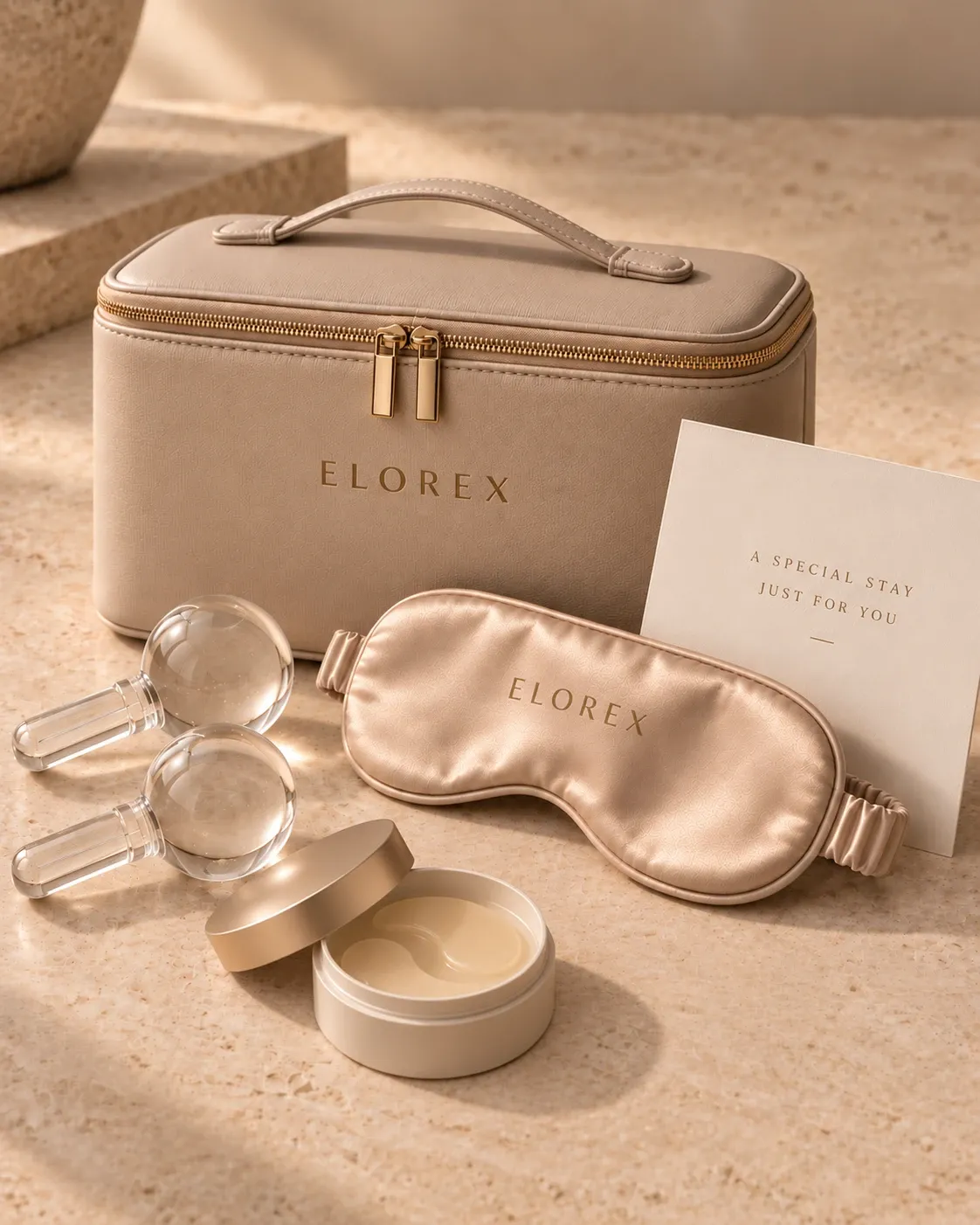 An Elorex vanity case with a satin eye mask, cooling eye rollers and eye cream, beside an 'A Special Stay Just For You' card